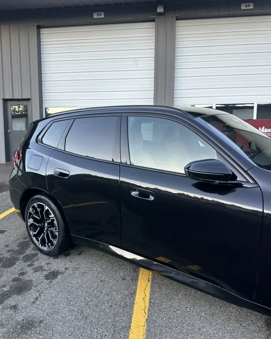Black hatchback side profile after wash